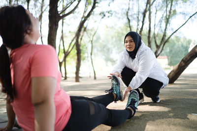 Side view of young woman exercising in park