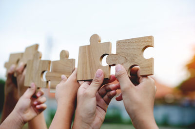 Cropped hand holding jigsaw puzzle