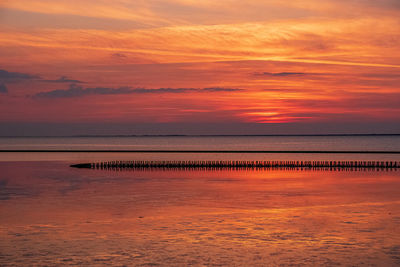 Scenic view of sea against orange sky