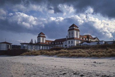 Houses on beach against sky