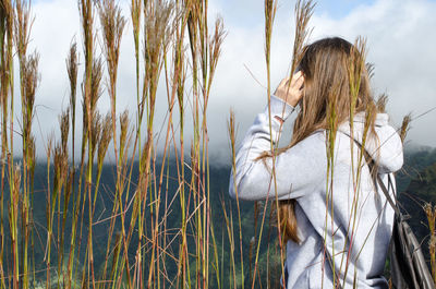 Woman on grass against sky