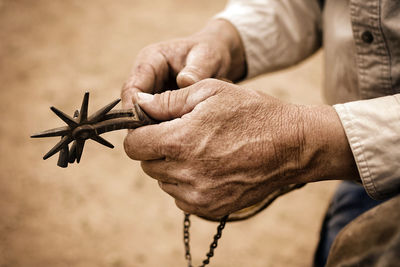 Cropped image of man holding hands