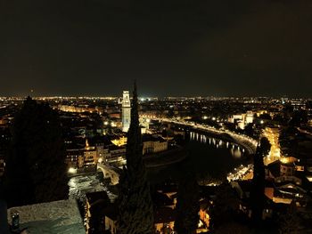 High angle view of illuminated buildings against sky at night