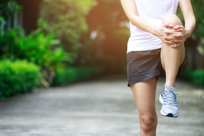 Low section of woman standing outdoors