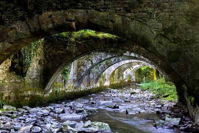 Arch bridge over river stream