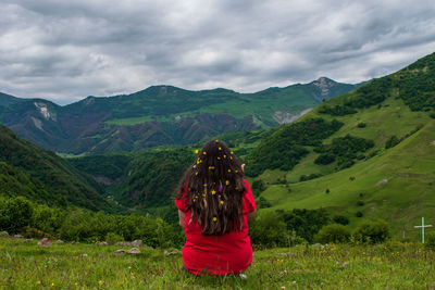 Rear view of woman against mountain range