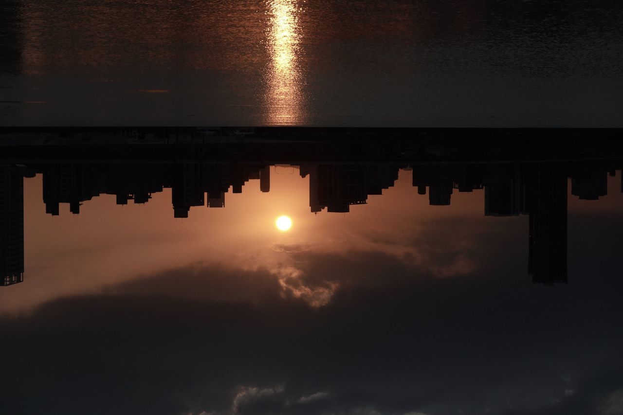 reflection, water, sky, darkness, cloud, light, nature, sunset, dawn, no people, architecture, silhouette, tranquility, lake, beauty in nature, built structure, sunlight, evening, horizon, outdoors, scenics - nature, tranquil scene