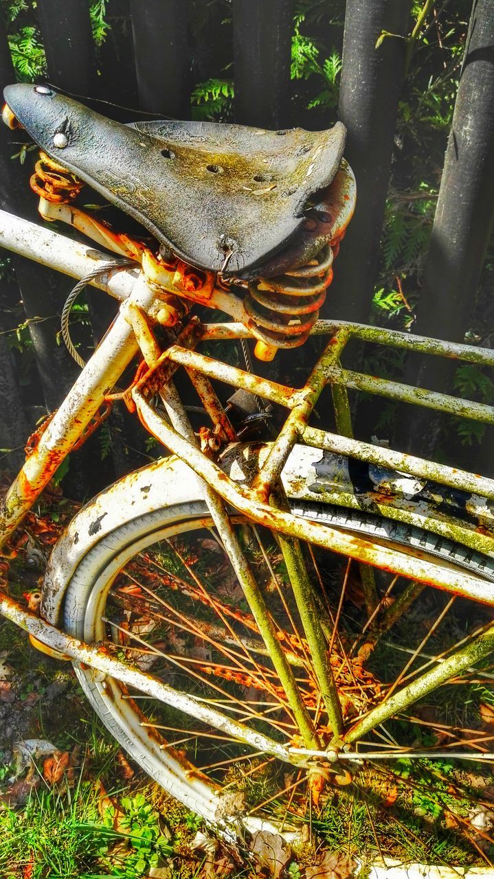 high angle view, grass, outdoors, metal, abandoned, old, day, plant, damaged, rusty, transportation, obsolete, sunlight, tree, growth, field, park - man made space, close-up, run-down, low section