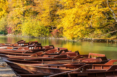 Wooden row boats by wooden pier on lake in plitvice lakes national park in croatia in autumn