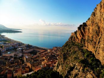 Panoramic view of sea and cityscape against sky