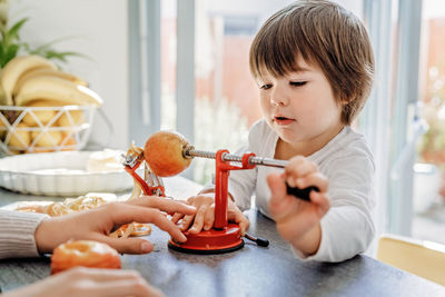 Boy playing with toy at home