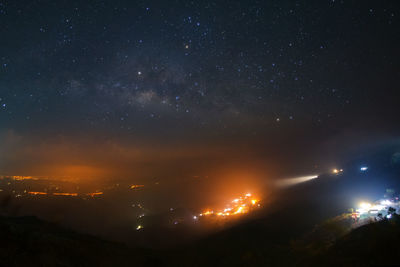 Aerial view of illuminated mountain against sky at night