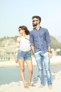 Young couple standing on beach