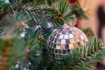 Christmas and new year holidays background. christmas tree decorated with silver disco ball. 
