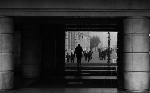 Rear view of people walking on building