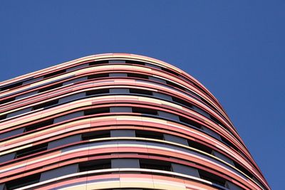 Low angle view of modern building against blue sky