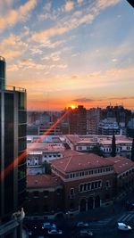 High angle view of buildings in city during sunset