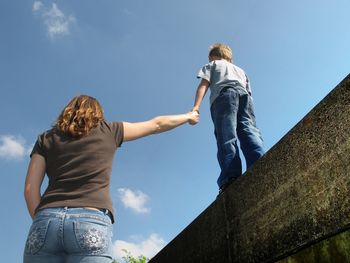 Low angle view of a woman against the sky