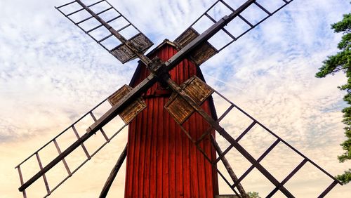 Low angle view of traditional windmill against sky