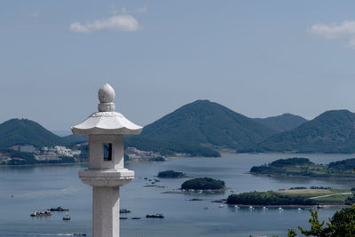 Scenic view of sea and mountains against sky