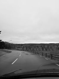 Road against sky seen through car windshield