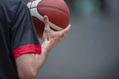 Midsection of man playing basketball