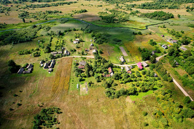 Scenic view of trees and houses on field