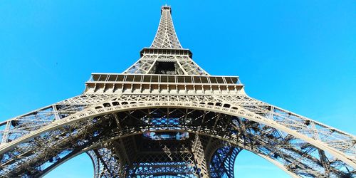 Low angle view of tower against blue sky