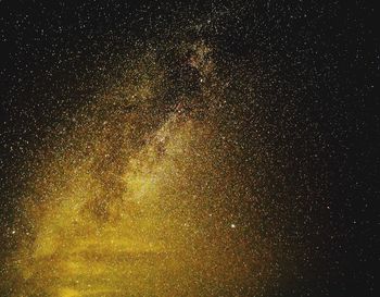 Low angle view of fireworks against sky at night