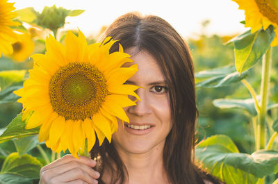 Close-up of woman with sunflower