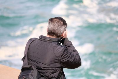 Rear view of man looking at sea