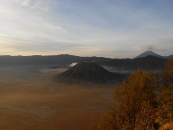 View of volcanic landscape against sky during sunrise