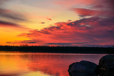 Scenic view of lake against orange sky