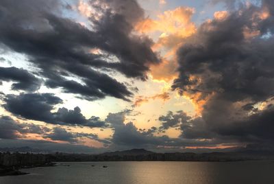 Scenic view of dramatic sky over sea during sunset