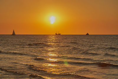 Scenic view of sea against orange sky