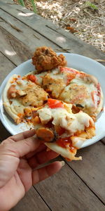High angle view of person holding food on table