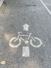 High angle view of arrow sign on road in city