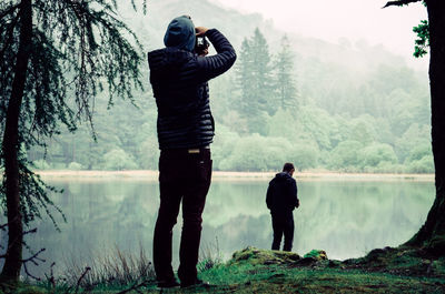 Man photographing in forest