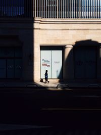 Full length of woman walking on tiled floor