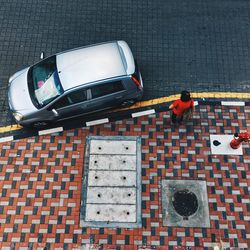 High angle view of man car on brick wall