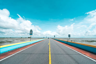 Road by sea against sky