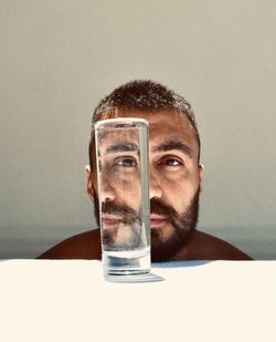 Portrait of young man against white background