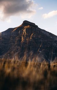 Low angle view of rocky mountain against sky