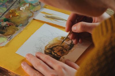 Close-up of hands working on table