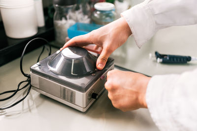 Closeup faceless scientist working in lab