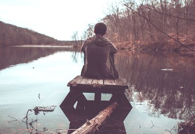 Rear view of man looking at lake