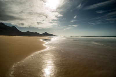 Scenic view of beach against sky