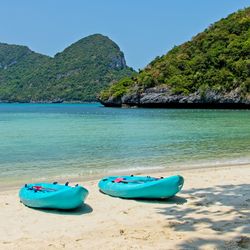 Boat moored on beach against clear sky