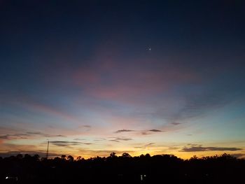 Silhouette trees against sky during sunset