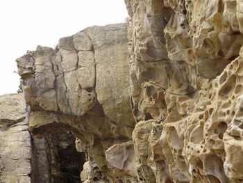 Close-up of rock formation against sky